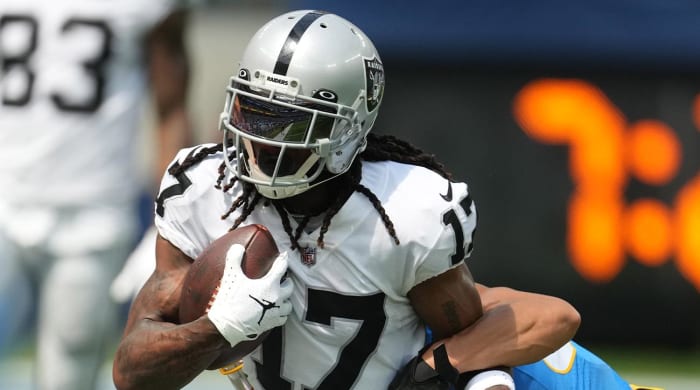 Sep 11, 2022; Inglewood, California, USA; Las Vegas Raiders wide receiver Davante Adams (17) attempts to break free from the grasp of Los Angeles Chargers safety Alohi Gilman (32) in the first half at SoFi Stadium.